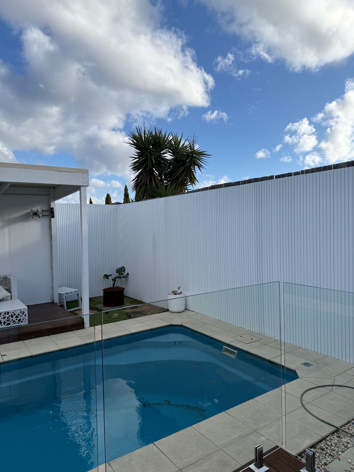White vertical batten feature wall by pool